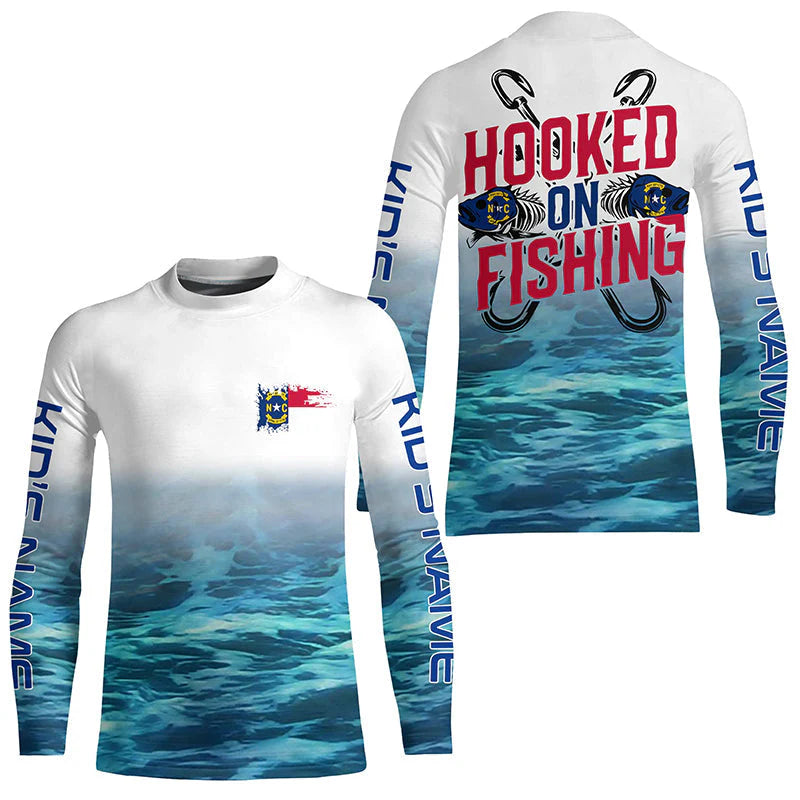 Kid Personalized North Carolina Flag Kid Long Sleeve Fishing Shirts, Hooked On Fishing Nc Fishing Shirt IPHW7033