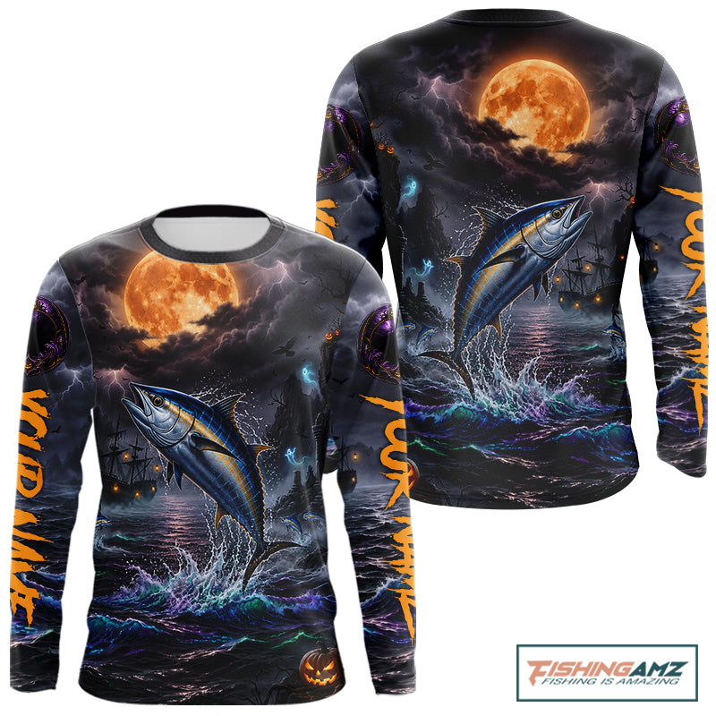 A long-sleeve crewneck shirt with an all-over Halloween-themed graphic print. The design features a large blue tuna fish jumping out of dark, churning water under a glowing orange full moon, with ghostly ships and purple storm clouds in the background.