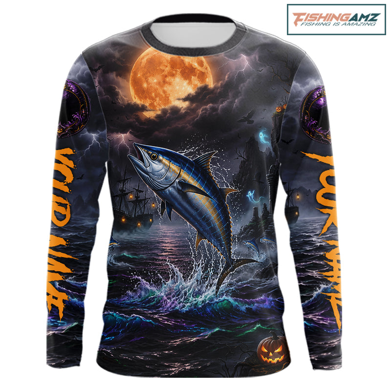 A long-sleeve crewneck shirt with an all-over Halloween-themed graphic print. The design features a large blue tuna fish jumping out of dark, churning water under a glowing orange full moon, with ghostly ships and purple storm clouds in the background.