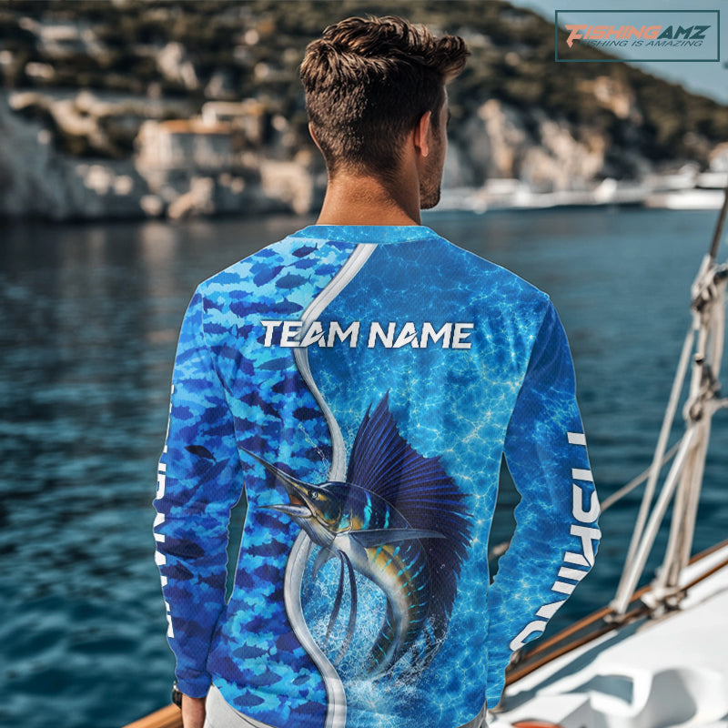 Angler wearing Sailfish fishing blue ocean camouflage performance long sleeve hooded fishing shirt on the water with personalized name