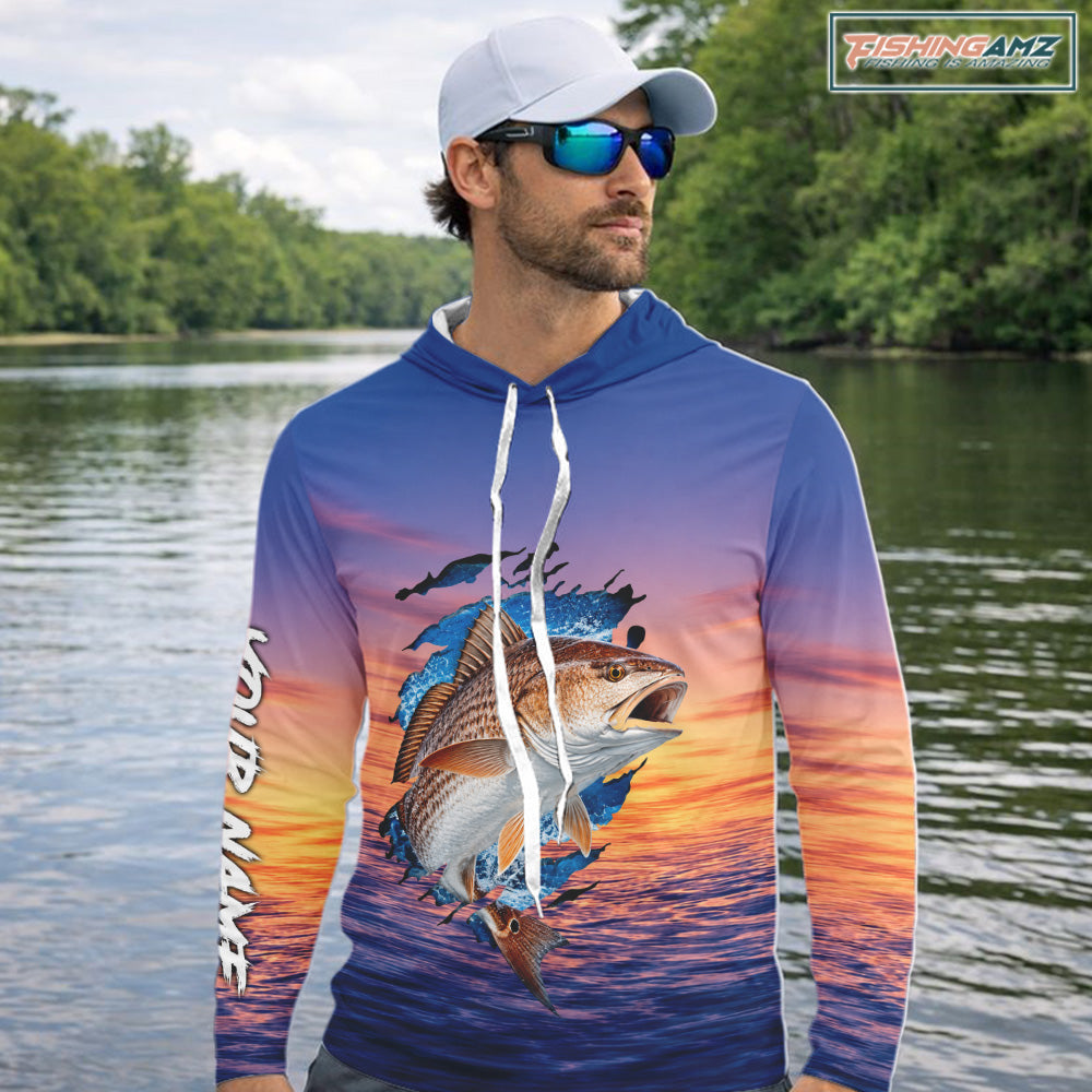 Angler wearing Redfish Fishing Sunset custom long sleeve hooded marlin offshore fishing shirt with custom name on the sleeve