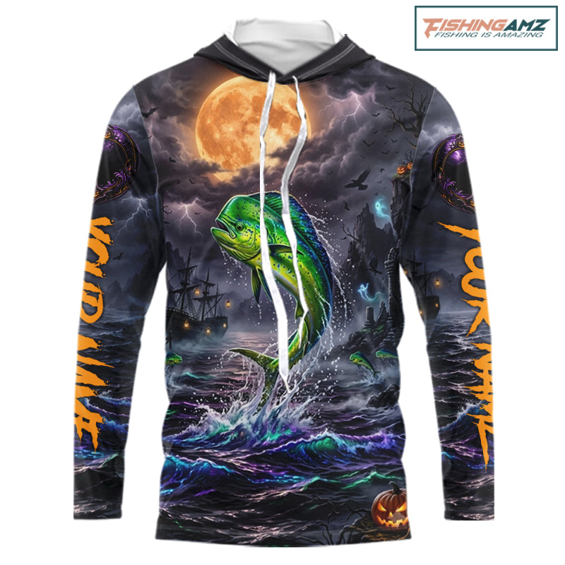 A long-sleeve hoodie with an all-over Halloween-themed graphic print featuring a green mahi-mahi fish jumping from dark ocean waves under a large orange full moon, with spooky ships and lightning in the background. The hoodie has white drawstrings and a white inner hood lining, shown on a plain white background with a FishingAmz logo in the top right corner.