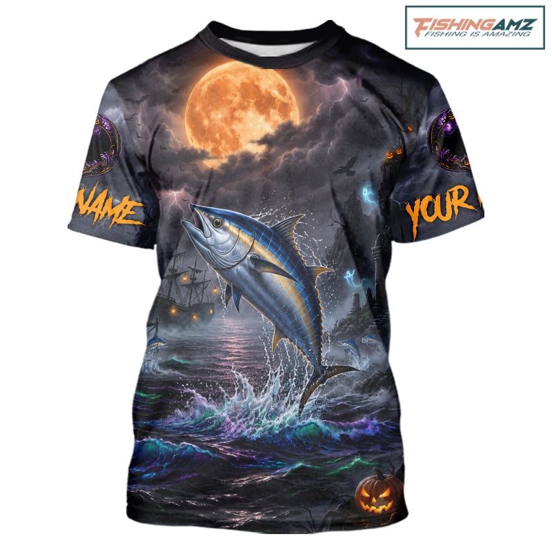 A custom short-sleeve t-shirt with an all-over Halloween-themed graphic print. The design features a large blue tuna jumping out of dark, stormy water under a glowing orange full moon, with customizable text placeholders 'NAME' and 'YOUR' on the sleeves, and a jack-o'-lantern at the bottom right.