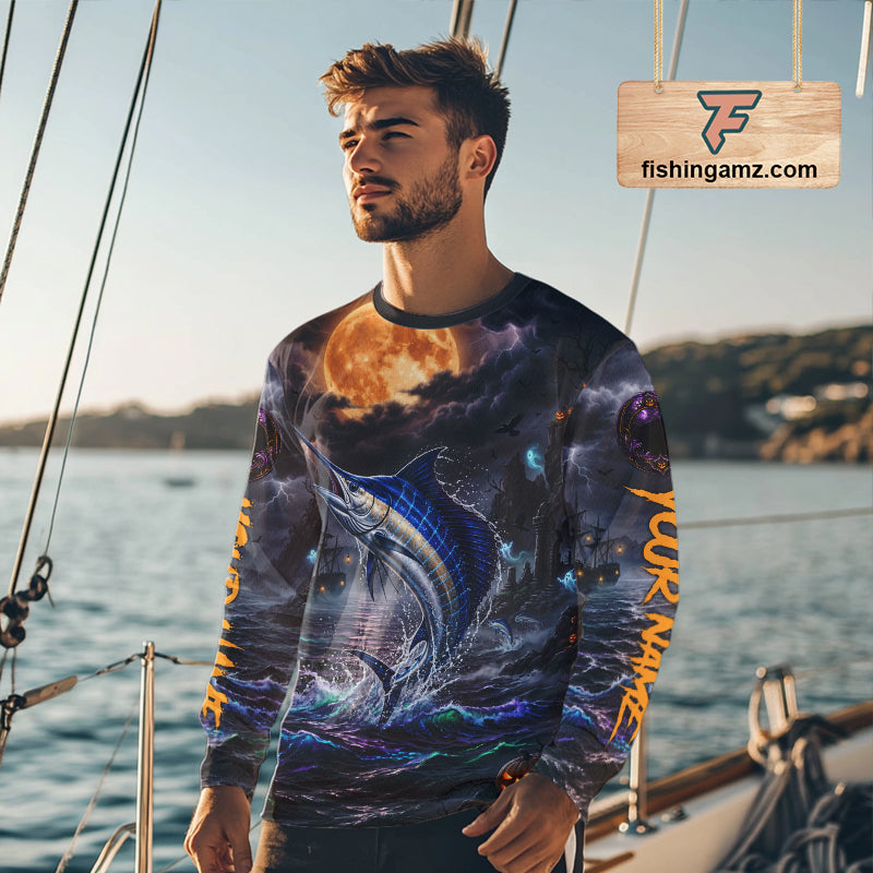 A man wearing a long-sleeve crewneck shirt with an all-over Halloween-themed graphic print featuring a marlin, a full moon, and orange vertical text on the sleeves