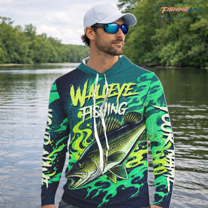 Angler wearing custom Walleye fishing green camo long sleeve hooded shirt on the water with personalized name