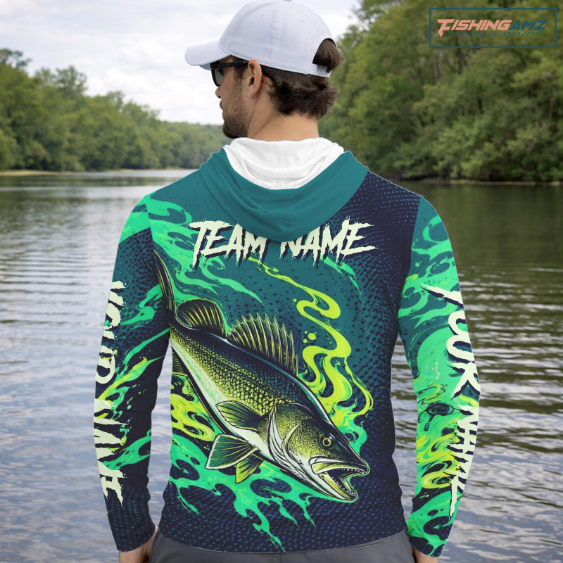 Angler wearing custom Walleye fishing green camo long sleeve hooded shirt on the water with personalized name