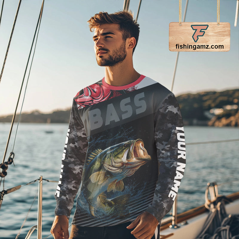 Bass angler wearing personalized black camo long sleeve fishing shirt on a boat
